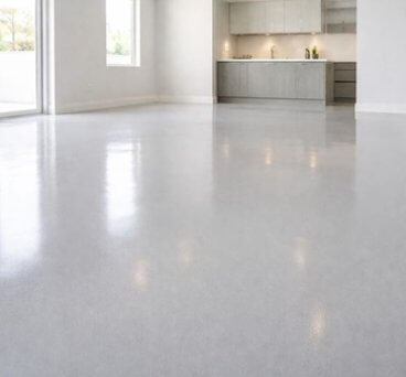 Shiny grey epoxy floor in a home dining room