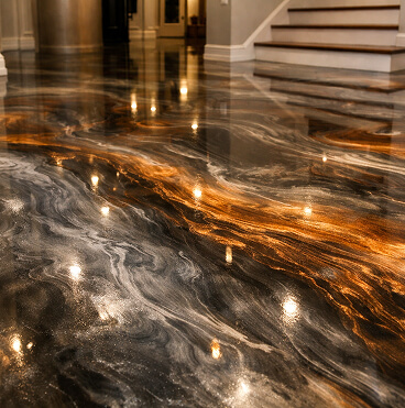 Swirling bronze and black metallic pattern on a floor at the base of the stairs