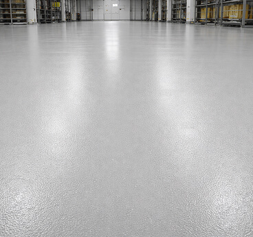 Shiny seamless grey floor in a warehouse